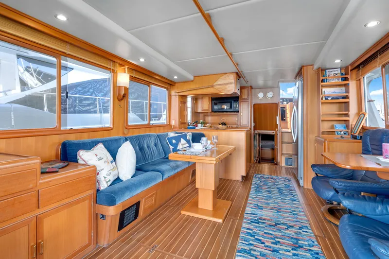 Slide: The Image of Luxurious interior of 2001 Fleming 55 Pilothouse yacht with elegant wood finishes and plush seating. - 10