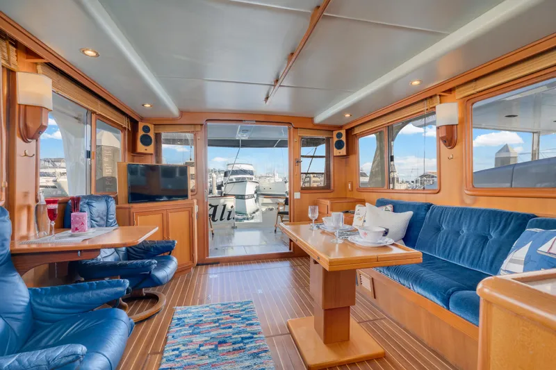 Slide: The Image of Luxurious interior of 2001 Fleming 55 Pilothouse yacht with elegant seating and dining area. - 11