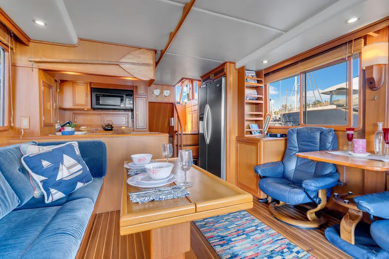 Slide: The Image of Luxurious interior of 2001 Fleming 55 Pilothouse yacht with dining and seating area. - 12