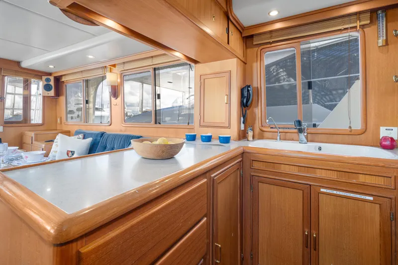 Slide: The Image of Interior of 2001 Fleming 55 Pilothouse yacht with wooden cabinetry and modern amenities. - 16
