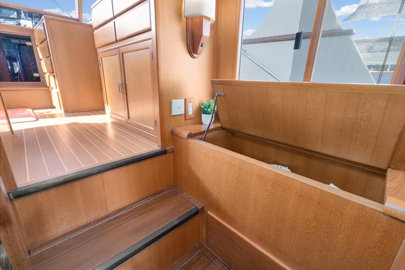 Slide: The Image of Interior of 2001 Fleming 55 Pilothouse yacht with wooden cabinetry and storage compartment. - 18