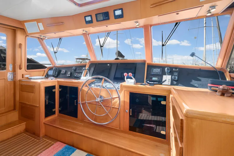 Slide: The Image of Pilothouse interior of 2001 Fleming 55 yacht with wooden finish and navigation equipment. - 20