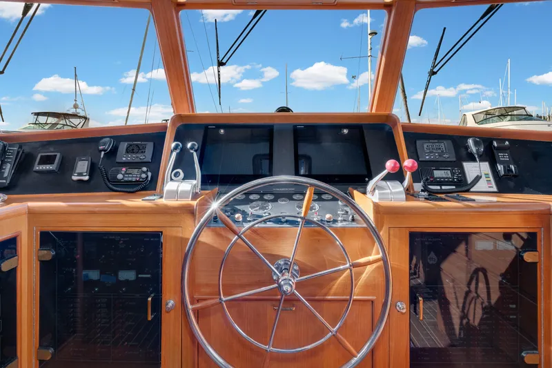 Slide: The Image of Pilothouse of 2001 Fleming 55 yacht with steering wheel and navigation controls. - 21