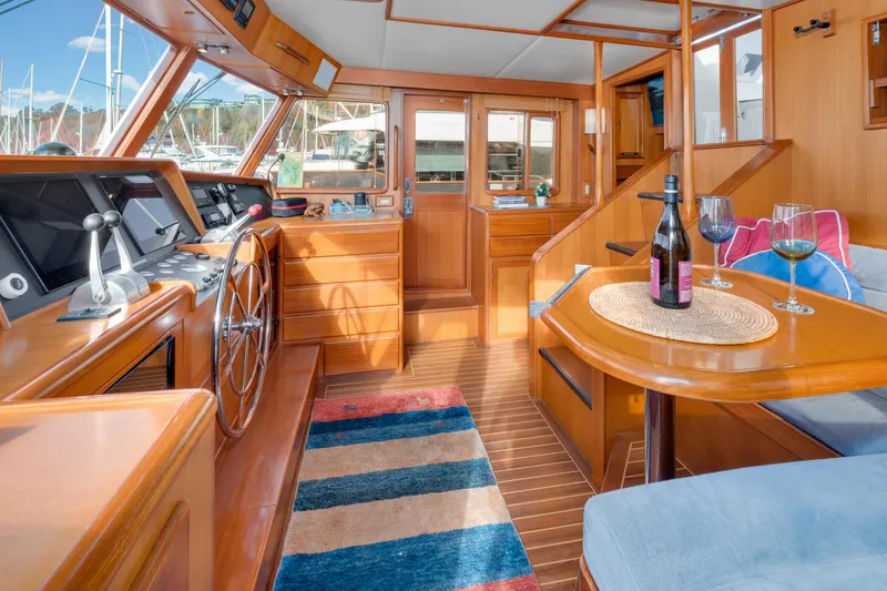 Slide: The Image of Luxurious 2001 Fleming 55 Pilothouse interior with wooden finishes and nautical decor. - 24