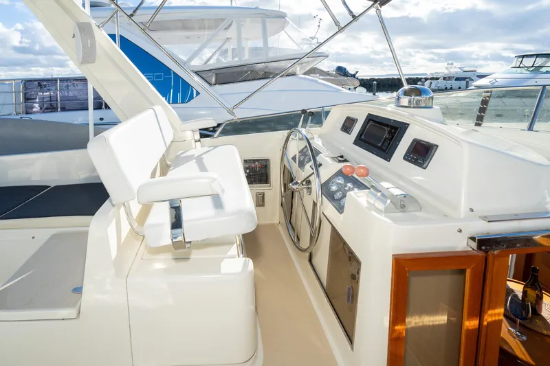 Slide: The Image of Pilothouse of 2001 Fleming 55 yacht with steering wheel and navigation instruments. - 29