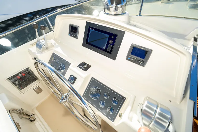 Slide: The Image of Pilothouse of 2001 Fleming 55 yacht with steering wheel and navigation controls. - 30