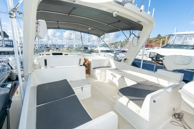 Slide: The Image of 2001 Fleming 55 Pilothouse yacht deck with seating, docked at marina under blue sky. - 34