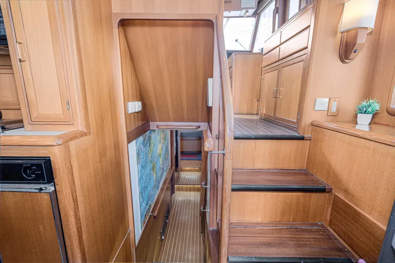 Slide: The Image of Interior of 2001 Fleming 55 Pilothouse with wooden stairs and cabinetry. - 41