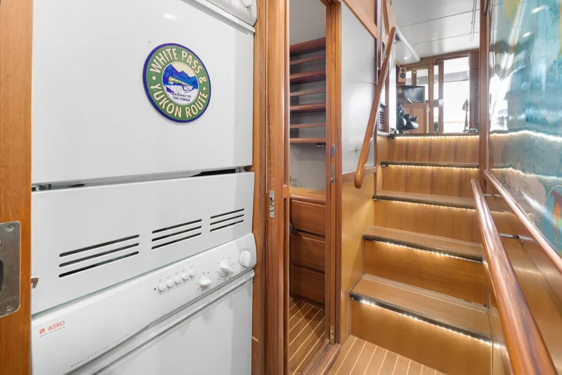 Slide: The Image of Interior of 2001 Fleming 55 Pilothouse with stairs and laundry area. - 42