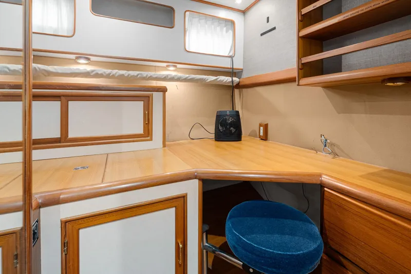 Slide: The Image of Interior workspace of 2001 Fleming 55 Pilothouse with wooden desk and blue chair. - 43