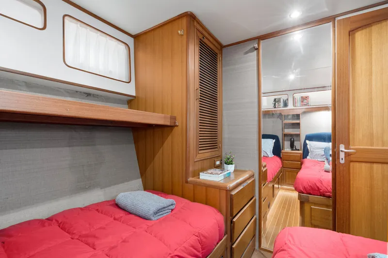 Slide: The Image of Interior of 2001 Fleming 55 Pilothouse yacht with cozy twin beds and wooden cabinetry. - 45