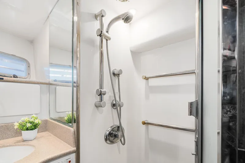 Slide: The Image of Luxurious bathroom in 2001 Fleming 55 Pilothouse yacht with modern shower and vanity. - 46