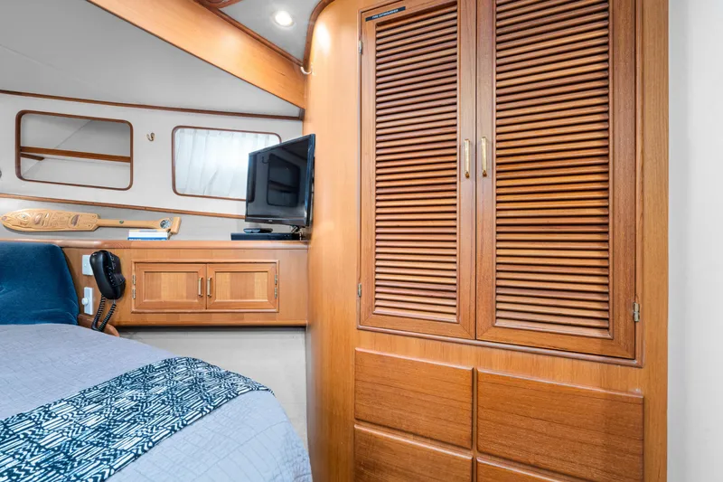 Slide: The Image of Interior of 2001 Fleming 55 Pilothouse with wooden cabinetry and cozy decor. - 49