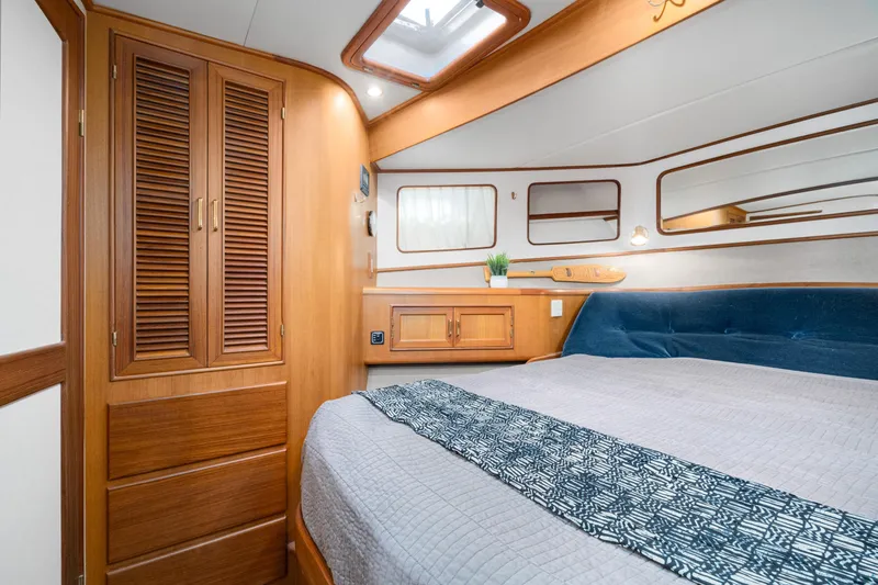 Slide: The Image of Luxurious cabin interior of 2001 Fleming 55 Pilothouse yacht with wood finishes. - 50