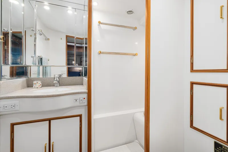 Slide: The Image of Luxurious bathroom in 2001 Fleming 55 Pilothouse yacht with elegant fixtures and ample storage. - 51