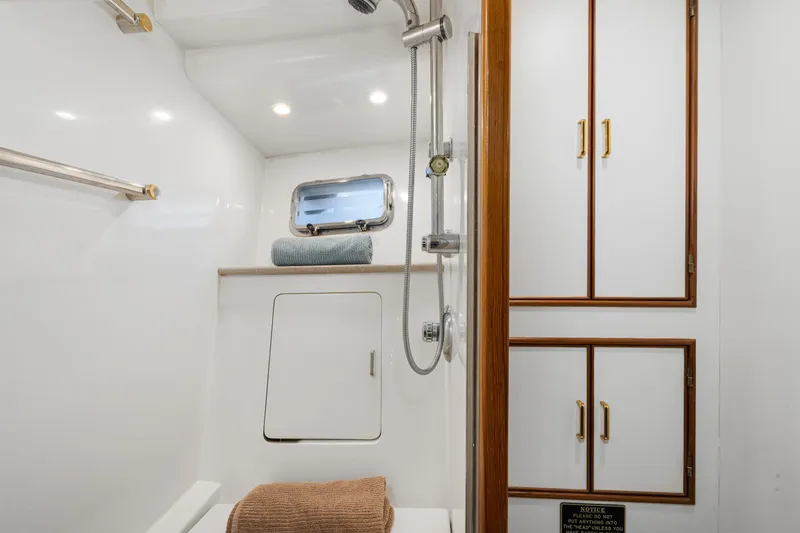 Slide: The Image of Bathroom interior of 2001 Fleming 55 Pilothouse yacht with shower and storage cabinets. - 52