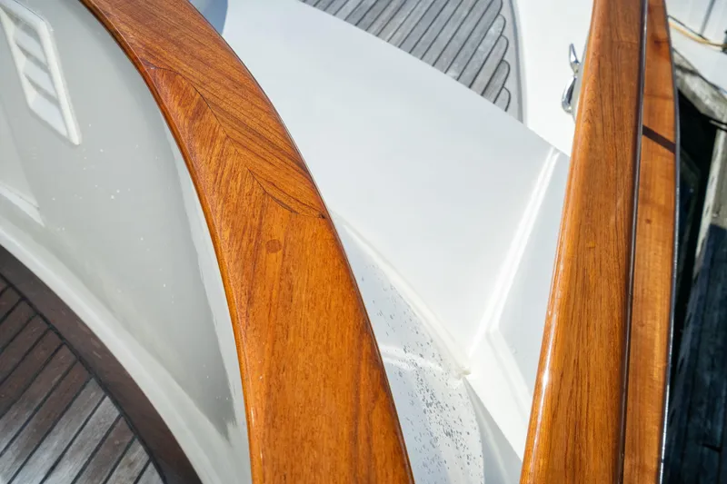 Slide: The Image of Close-up of 2001 Fleming 55 Pilothouse yacht's polished wooden railing and deck. - 55