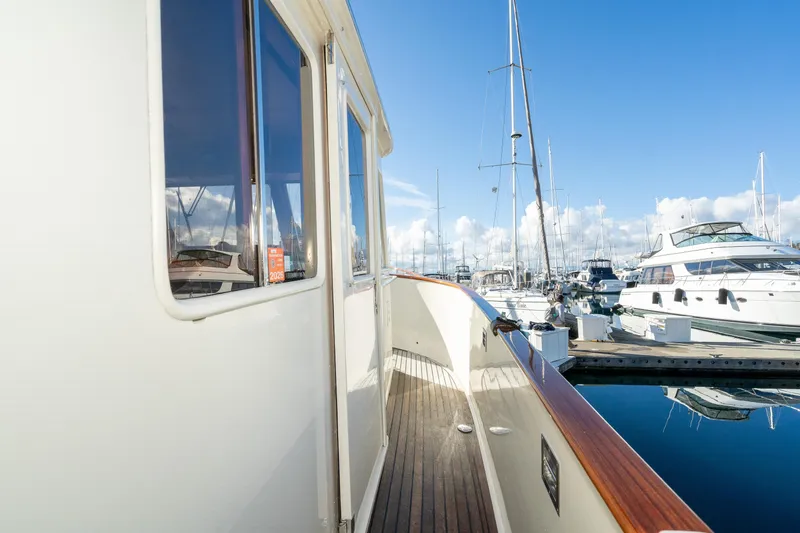 Slide: The Image of 2001 Fleming 55 Pilothouse yacht docked at marina under clear blue sky. - 57