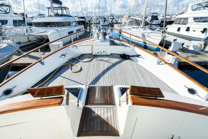 Slide: The Image of 2001 Fleming 55 Pilothouse yacht deck at marina, surrounded by other boats. - 59