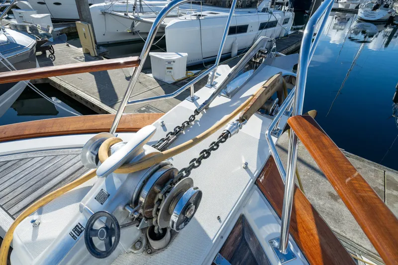 Slide: The Image of Bow of 2001 Fleming 55 Pilothouse yacht with anchor chain and wooden railings. - 61