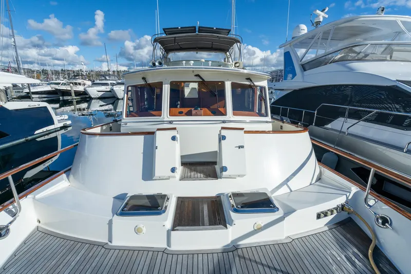 Slide: The Image of 2001 Fleming 55 Pilothouse yacht docked at marina under blue sky. - 62