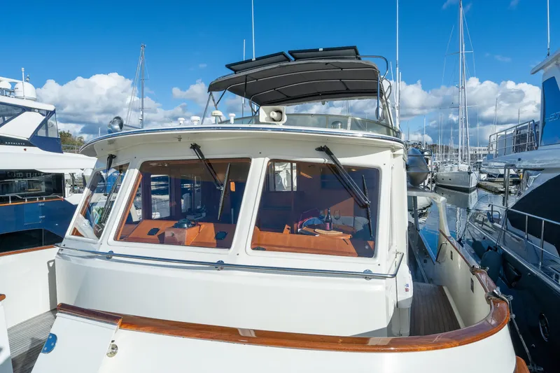 Slide: The Image of 2001 Fleming 55 Pilothouse yacht docked at marina under blue sky. - 64