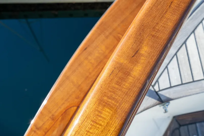 Slide: The Image of Polished wood detail on 2001 Fleming 55 Pilothouse yacht, reflecting sunlight. - 65