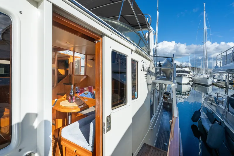 Slide: The Image of 2001 Fleming 55 Pilothouse yacht docked, showcasing elegant interior and marina view. - 66