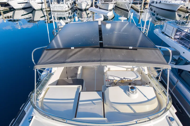 Slide: The Image of 2001 Fleming 55 Pilothouse yacht with solar panels docked at marina. - 69