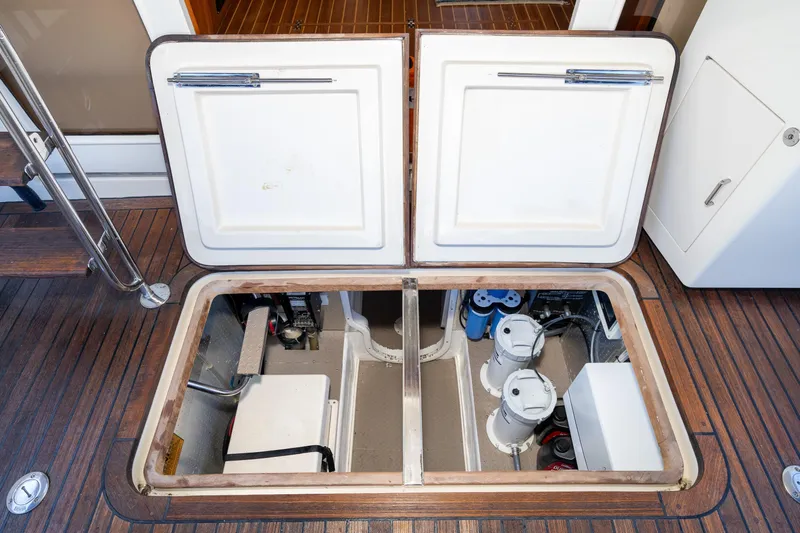 Slide: The Image of Engine compartment of 2001 Fleming 55 Pilothouse yacht with open hatch and visible equipment. - 73