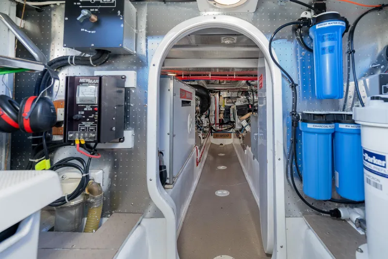 Slide: The Image of Engine room of 2001 Fleming 55 Pilothouse yacht with equipment and filtration systems. - 74