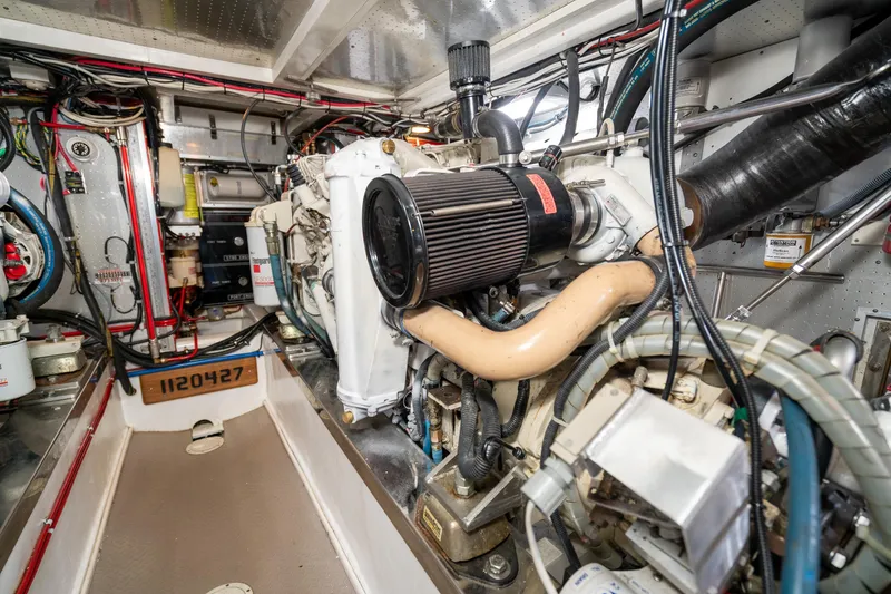 Slide: The Image of Engine room of a 2001 Fleming 55 Pilothouse yacht, showcasing detailed machinery. - 77