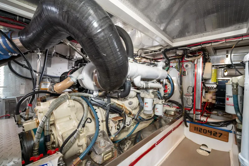 Slide: The Image of Engine room of 2001 Fleming 55 Pilothouse yacht, showcasing complex machinery and wiring. - 78