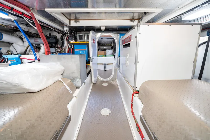 Slide: The Image of Engine room of 2001 Fleming 55 Pilothouse yacht, showcasing equipment and storage. - 80