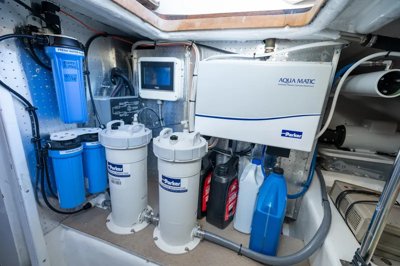 Slide: The Image of Engine room of 2001 Fleming 55 Pilothouse with water filtration system and equipment. - 81