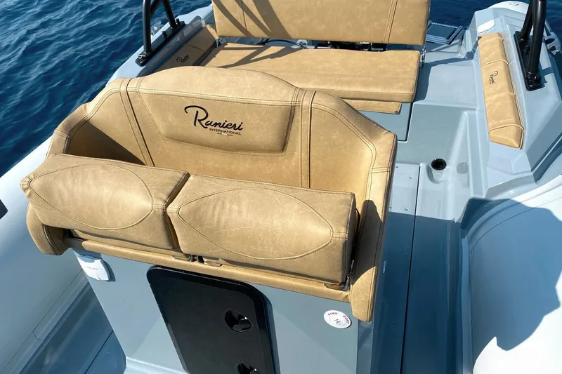 Slide: The Image of 2023 Ranieri CAYMAN 26 SPORT boat interior with tan leather seating. - 10
