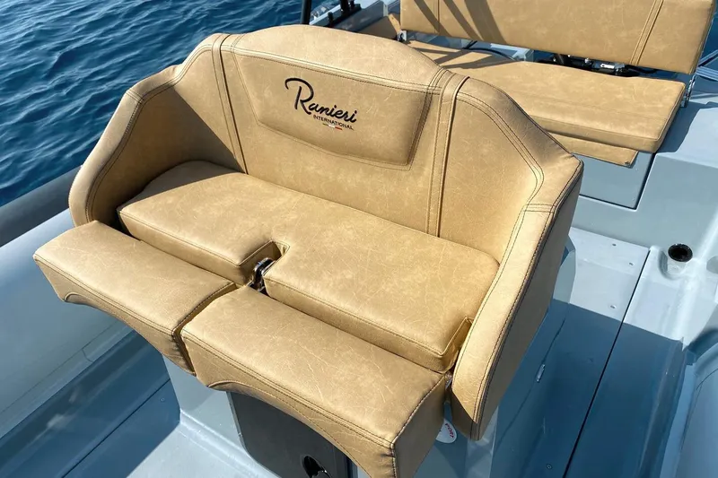 Slide: The Image of Luxurious seating on 2023 Ranieri CAYMAN 26 SPORT boat, featuring tan upholstery. - 11