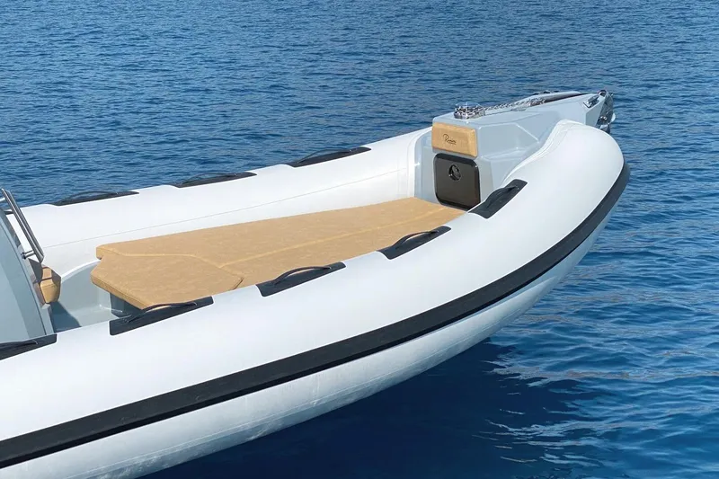 Slide: The Image of 2023 Ranieri CAYMAN 26 SPORT boat on calm blue water. - 2