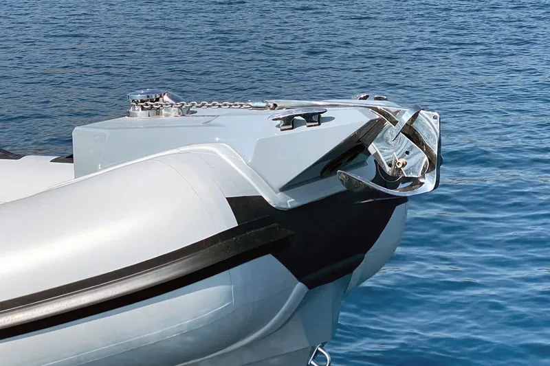 Slide: The Image of 2023 Ranieri CAYMAN 26 SPORT boat bow with anchor, floating on calm blue water. - 5