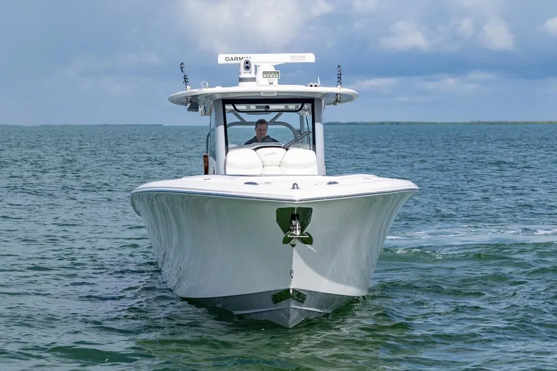 Slide: The Image of 2024 Blackwater 43 Sportfish boat cruising on open water under a cloudy sky. - 24