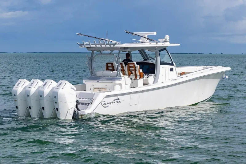 Slide: The Image of 2024 Blackwater 43 Sportfish boat with four engines cruising on open water. - 25