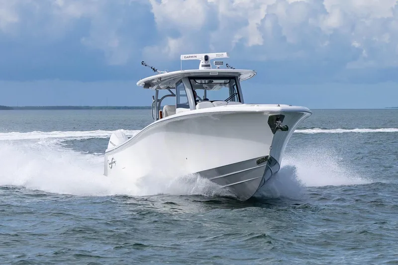 Slide: The Image of 2024 Blackwater 43 Sportfish boat cruising on open water under cloudy skies. - 27
