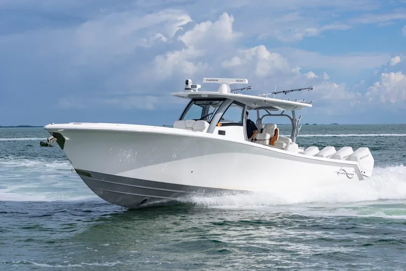 Slide: The Image of 2024 Blackwater 43 Sportfish boat cruising on open water under a cloudy sky. - 29