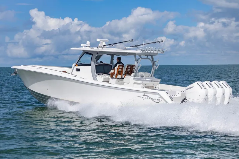 Slide: The Image of 2024 Blackwater 43 Sportfish boat cruising on open water under a blue sky. - 30