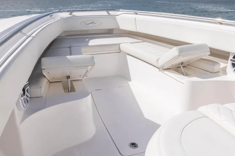 Slide: The Image of 2024 Blackwater 43 Sportfish boat interior with white seating and ocean view. - 37