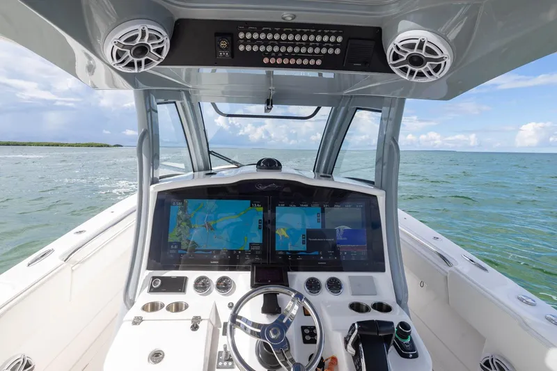 Slide: The Image of 2024 Blackwater 43 Sportfish helm with advanced navigation screens on open water. - 45