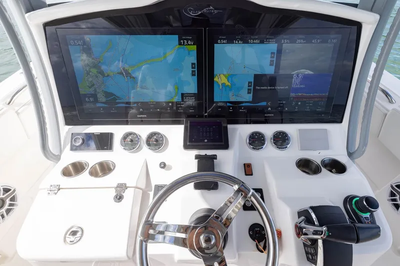 Slide: The Image of 2024 Blackwater 43 Sportfish helm with dual Garmin displays and modern controls. - 46