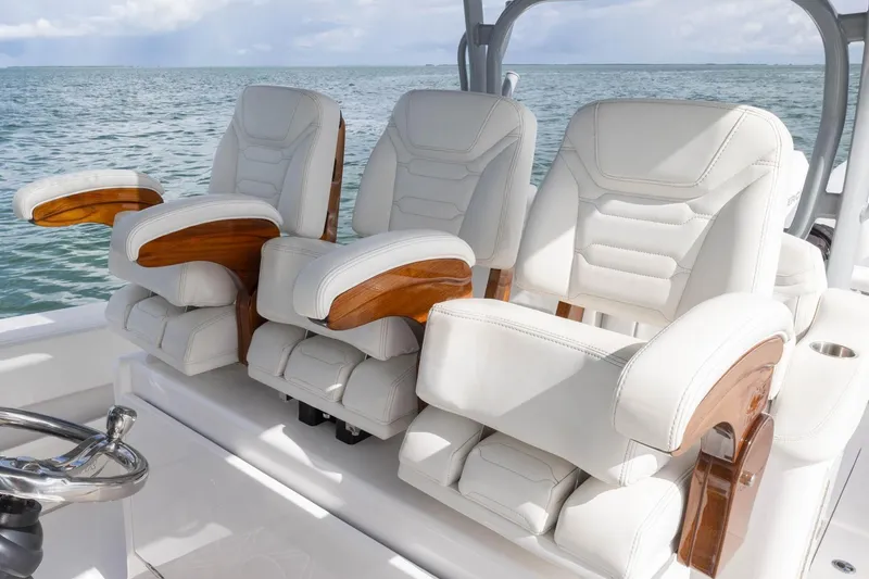 Slide: The Image of Luxurious seating on 2024 Blackwater 43 Sportfish boat, featuring white leather and wooden accents. - 48