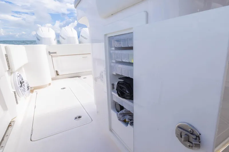 Slide: The Image of 2024 Blackwater 43 Sportfish boat interior with storage compartments and Mercury engines. - 50