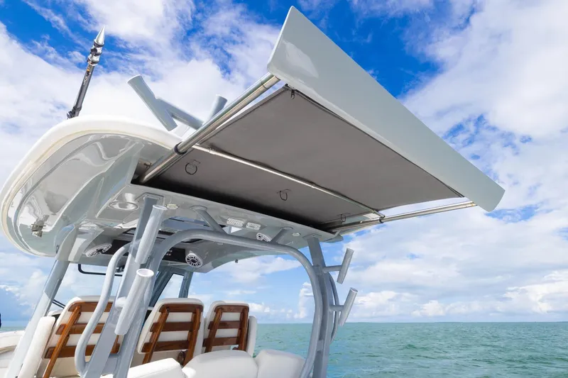 Slide: The Image of 2024 Blackwater 43 Sportfish boat with canopy, ocean view, and blue sky background. - 52